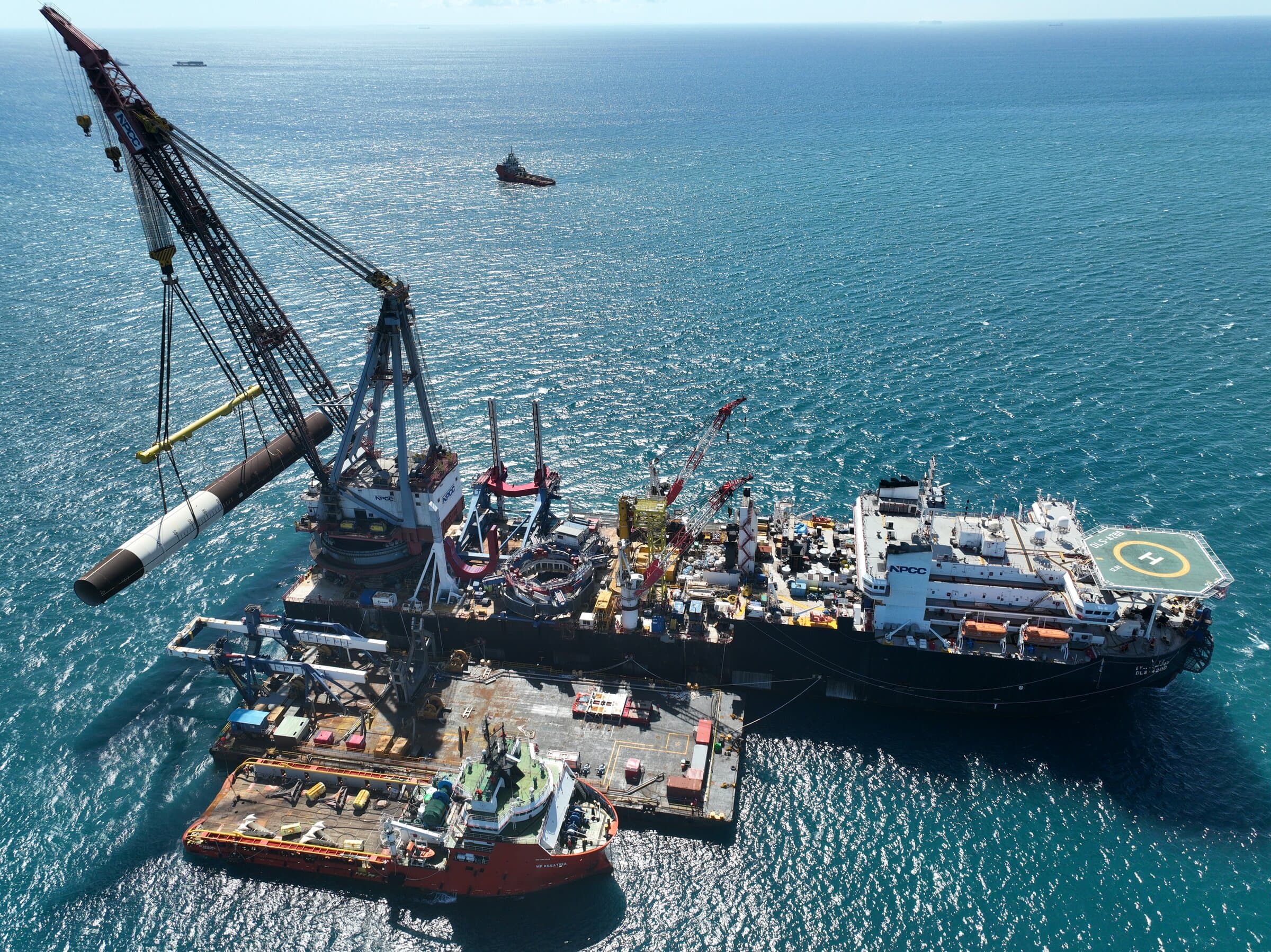 Heavy-lift vessel performing offshore construction with crane operations at sea